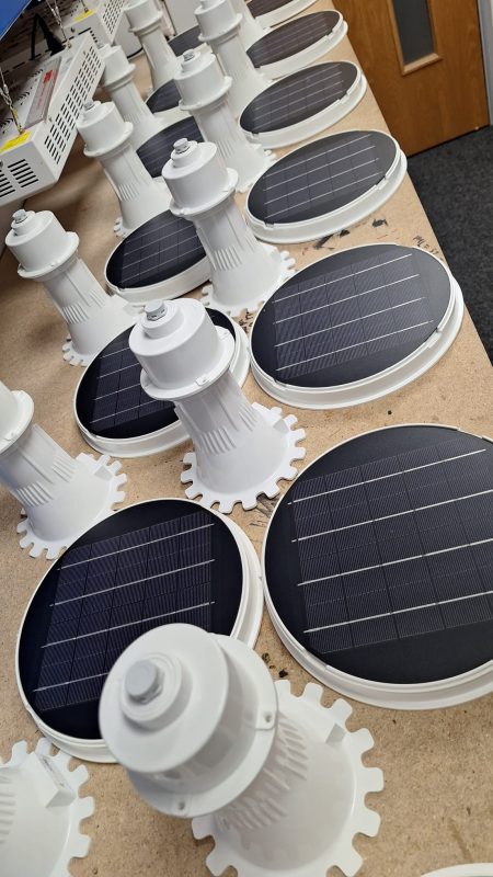 Solar bollard components in a factory setting.